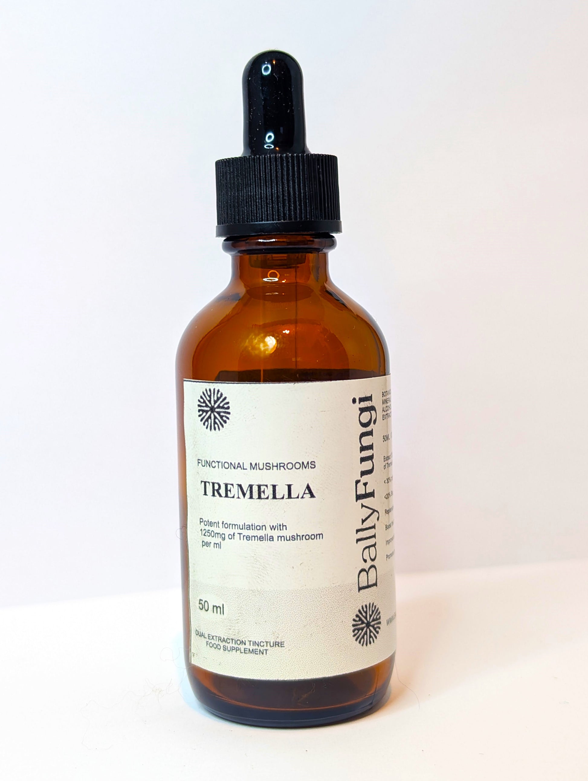 Tremella Mushroom Tincture bottle – A premium dark amber glass bottle with a dropper cap, labeled 'Tremella Mushroom Tincture – Hydration & Skin Glow (Dual Extracted, 50ml)'. Placed on a minimalist background with Tremella mushrooms and water droplets, symbolizing deep hydration and skin nourishment. Perfect for boosting skin elasticity and moisture retention