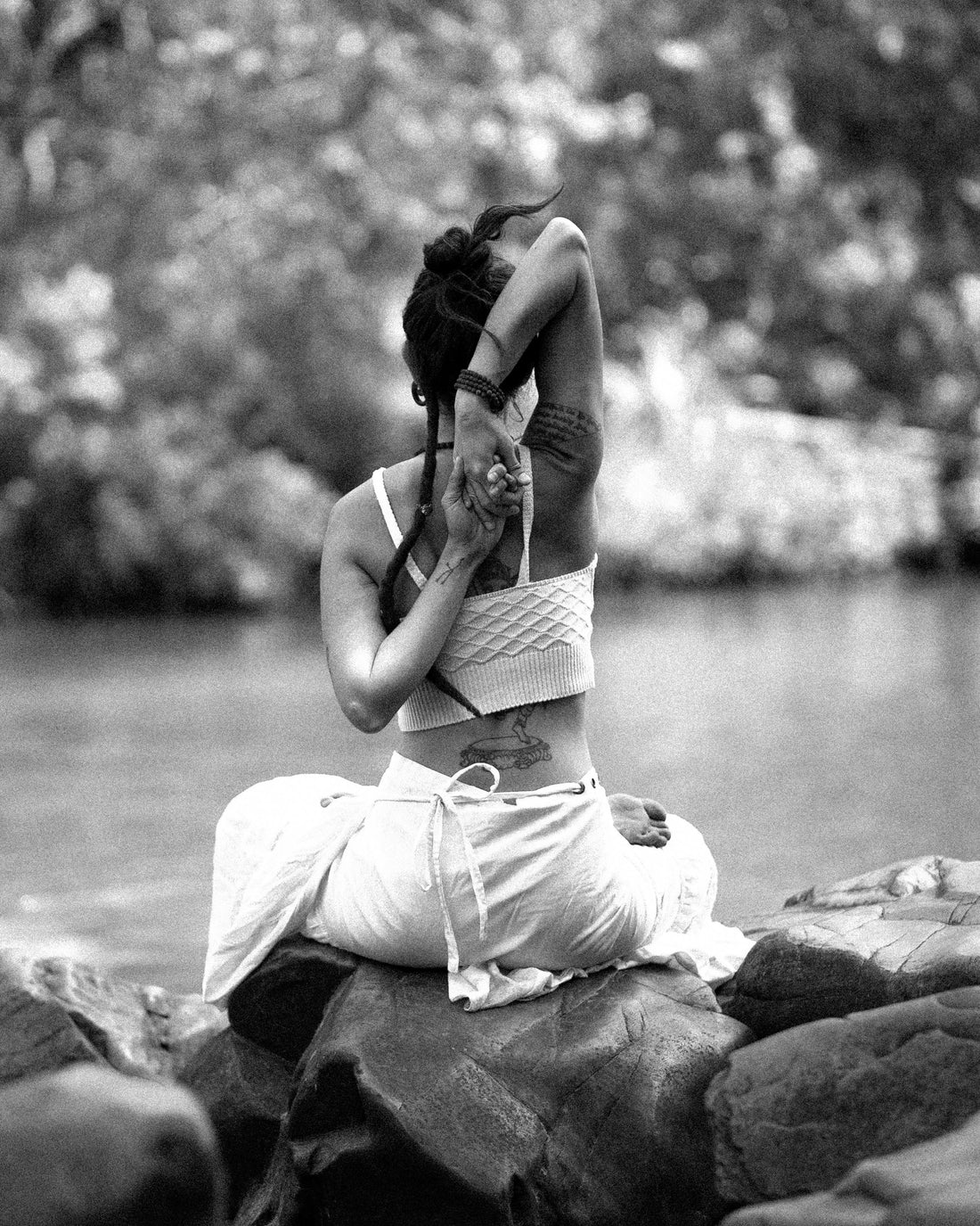 woman sitting on rock